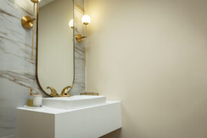 white marble sink with gold sensor faucet